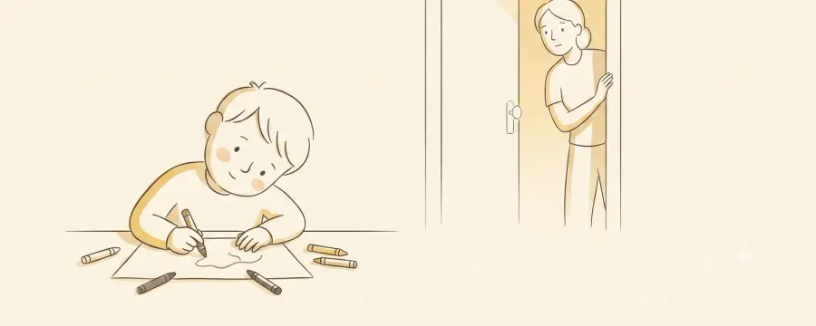 A young child drawing at a table with their head tilted and bent low over the paper, while a parent watches quietly from a doorway.