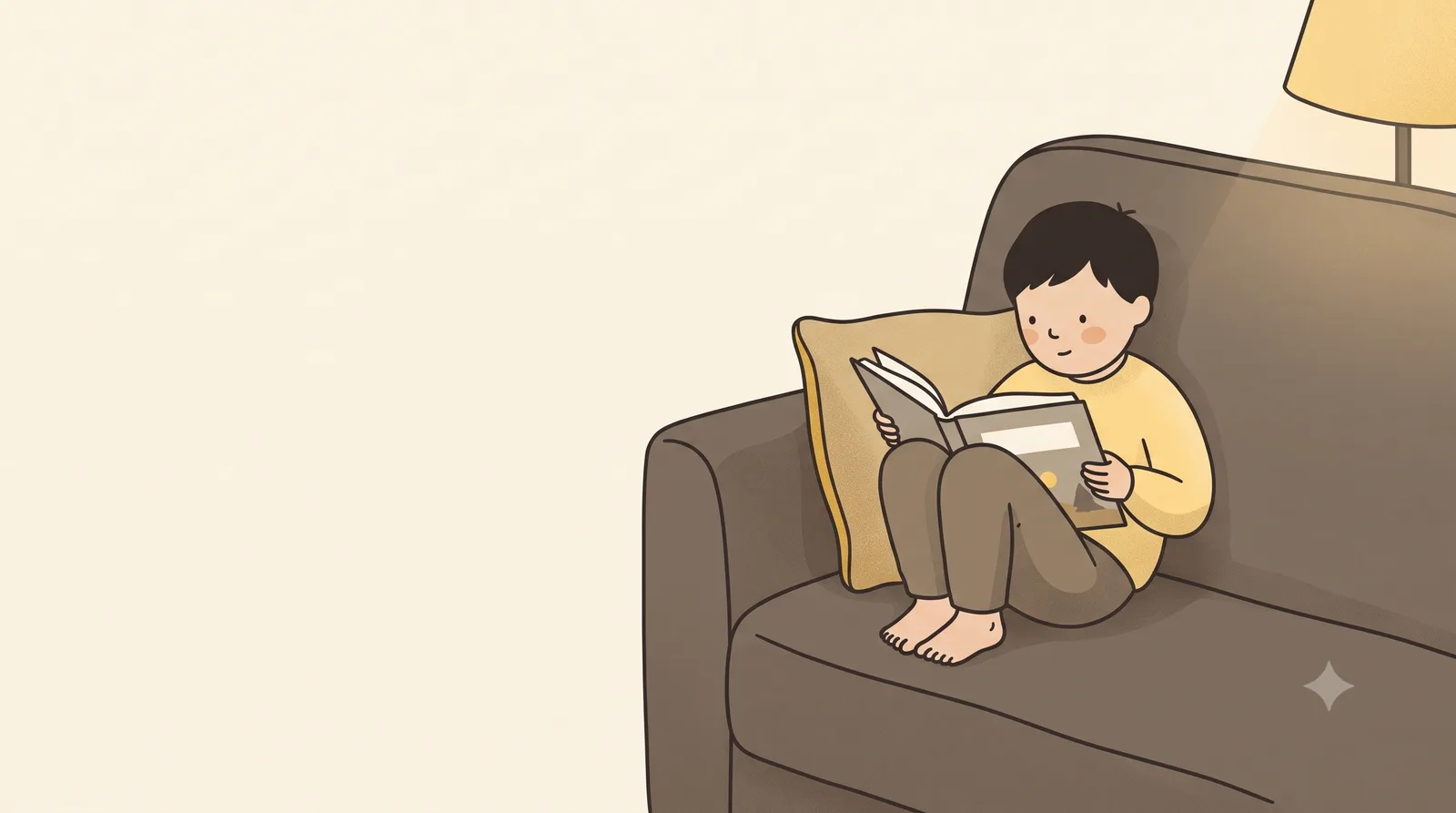 A child curled up on a sofa under a lamp, holding an open picture book at a comfortable distance with their elbow tucked against their side.